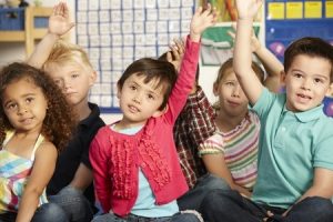 Children raising their hands